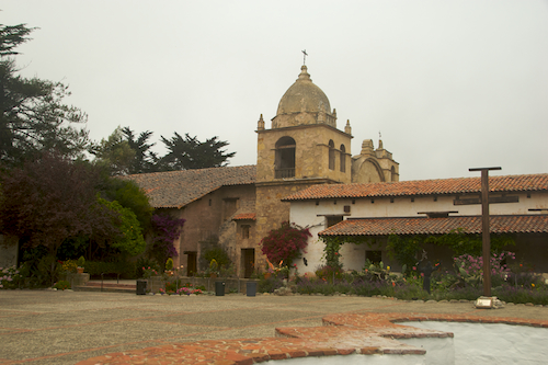 carmel_mission_courtyard Carmel mission courtyard with tower, crosses, and fountain.